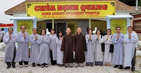 Members of the Dinh Quang community posing in their robes